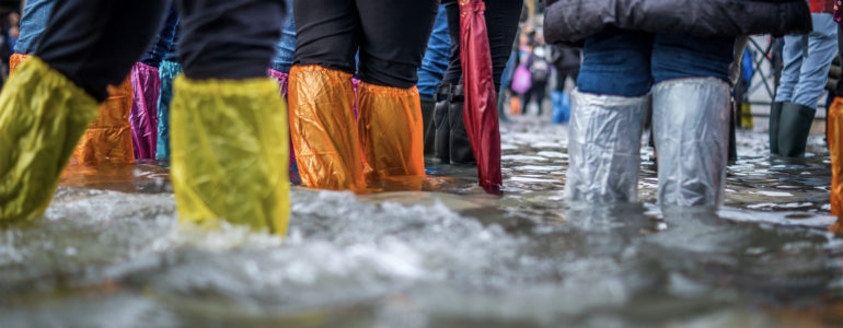 people with boots in flood water