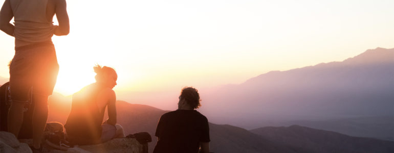 students in sunset light on mountain