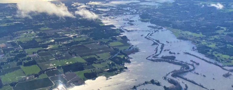 The flooded Nooksack River in Whatcom County on Nov. 16, with the San Juan Islands in the background