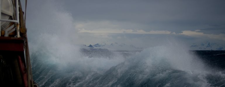 wave crashes onto buoy