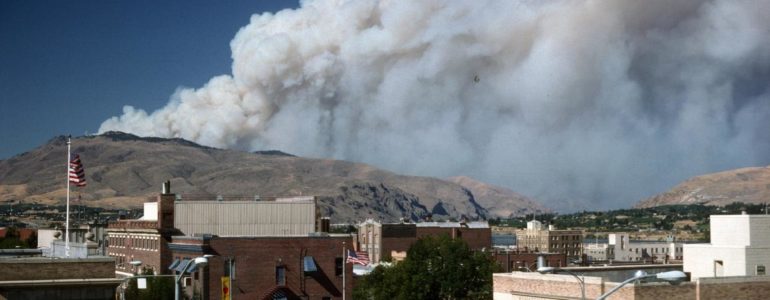 Photo of wildfire smoke over a city courtesy of US Forest Service