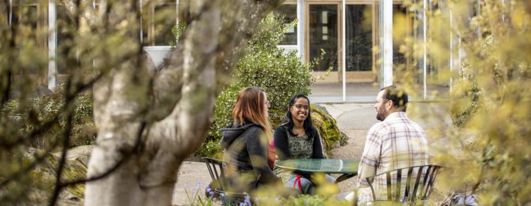 Image of grad students talking outside