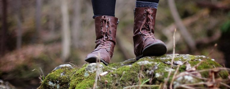 boots standing on a mossy rock