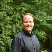 Ben Packard in front of trees