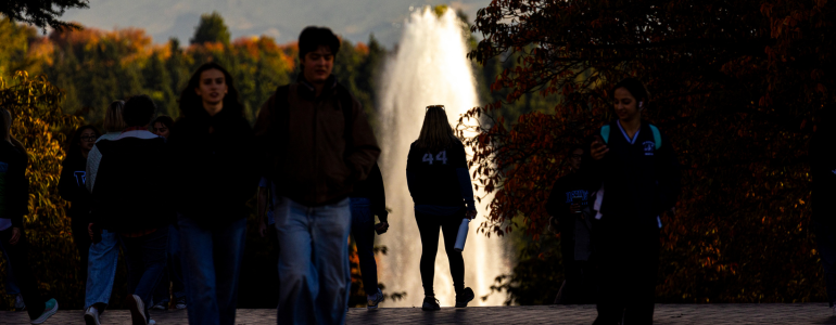 Image of UW student in front of fountain on campus.