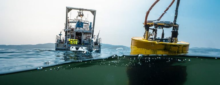 Makah Bay 42 real-time mooring with the R/V Storm Petrel in the background. Photo: Nick Zachar/NOAA